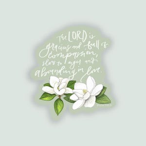 May include: A sticker featuring white magnolia flowers with green leaves. The text "The LORD is gracious and full of compassion, slow to anger and abounding in love" is written in cursive. The text "Psalm 145:8" is also included.