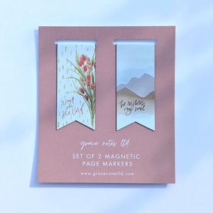 May include: A set of two magnetic page markers on a pink card. One marker features a floral design with the text "Wait on the Lord." The other shows a mountain scene with the text "he restores my soul."