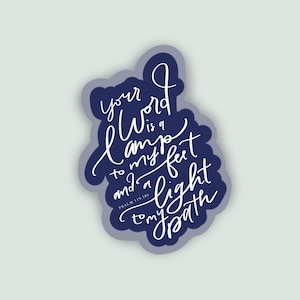 May include: A sticker with a dark blue irregular border. The sticker has the quote "Your word is a lamp to my feet and a light to my path" in white script. The text "Psalm 119:105" is at the bottom.