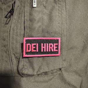 Patch: Pink and Black Flight Suit Morale Patch &quot;DEI Hire&quot; (Pencil Tab size, 2&quot;x1&quot;) w/Velcro Backing