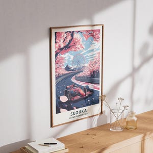 May include: A framed poster featuring a Formula 1 race car speeding on a track, with cherry blossoms and a Ferris wheel in the background. The poster reads "SUZUKA JAPAN GRAND PRIX".