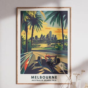May include: A framed art print featuring a Formula 1 race car speeding on a track, with palm trees and a city skyline in the background. The print has the text "MELBOURNE AUSTRALIA GRAND PRIX" at the bottom. The color palette includes shades of yellow, green, and orange.