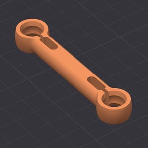 以下が含まれることがあります： 3Dレンダリングされたオレンジ色の機械部品。この部品は、2つの円形端部を持つ円筒形の中央部を持っています。各端部には円形の開口部があります。中央部の側面には長方形の切り欠きがあります。