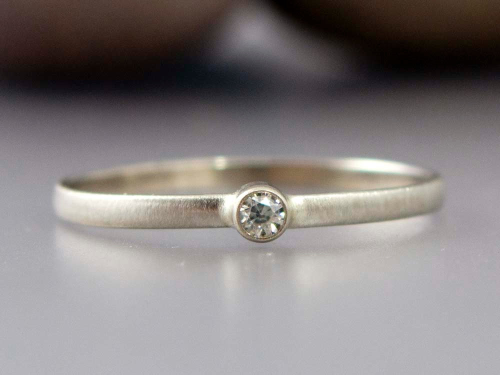 thin gold ring with tiny diamond