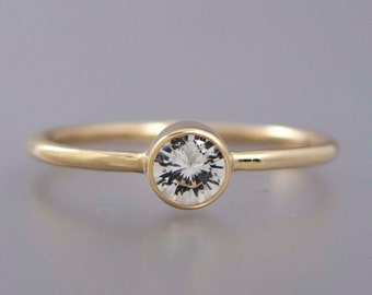 Quarter Carat Diamond Engagement Ring in 14k Gold with a 4mm solitaire bezel and a 1.3mm round band