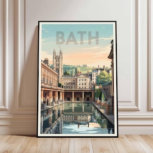 May include: A framed art print featuring a stylized illustration of Bath, England. The artwork depicts the city's architecture, including a prominent church and a reflecting pool, with the word "BATH" across the top. The color palette includes blues, oranges, and browns.
