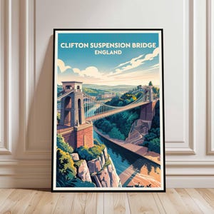 Puede incluir: Una impresión artística enmarcada del Puente Colgante de Clifton en Inglaterra. La obra de arte muestra el puente sobre un río, rodeado de árboles verdes y un cielo azul con nubes. El texto "Clifton Suspension Bridge England" está en la parte superior.