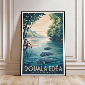 May include: A framed art print depicting a tranquil river scene with three manatees. The artwork is in a vintage travel poster style, with the text "DOUALA EDÉA NATIONAL PARK, ZOON" at the bottom. The colour scheme includes blues, greens, and a soft orange, evoking a sense of calm.