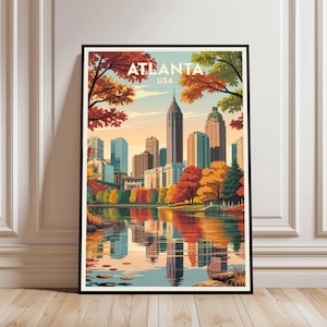 May include: A framed art print featuring a stylized illustration of the Atlanta, USA skyline reflected in a lake. The artwork showcases the city's skyscrapers, autumn foliage in shades of red, orange, and yellow, and the text "ATLANTA USA" at the top.