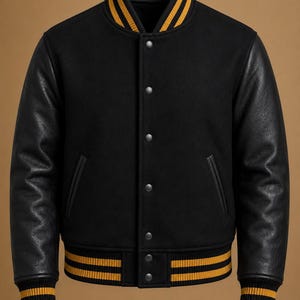 May include: A black varsity jacket featuring long black sleeves, a black body, and a ribbed collar and cuffs with yellow stripes. The jacket includes a front button closure with silver-toned snaps and two side pockets with black trim.