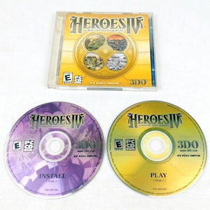 May include: A PC game titled "Heroes IV of Might and Magic" is displayed. The image shows a CD case and two CDs. The case has a gold and blue design. One CD is purple and labeled "Install," and the other is gold and labeled "Play."