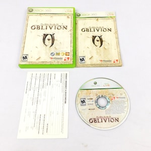May include: Two Xbox 360 game cases and a game disc for The Elder Scrolls IV: Oblivion. The cases are green and cream-colored, with the game title and logo prominently displayed. A product warranty and registration form is also included.