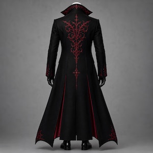 Back view of an elaborate Gothic vampire coat with ornate red embroidery extending across the shoulders and down the long black tailcoat. Contrasting crimson inner panels, sculpted tailoring and decorative hem details complete this Victorian steampunk design for cosplay, masquerade balls, gothic weddings and theatrical costumes.