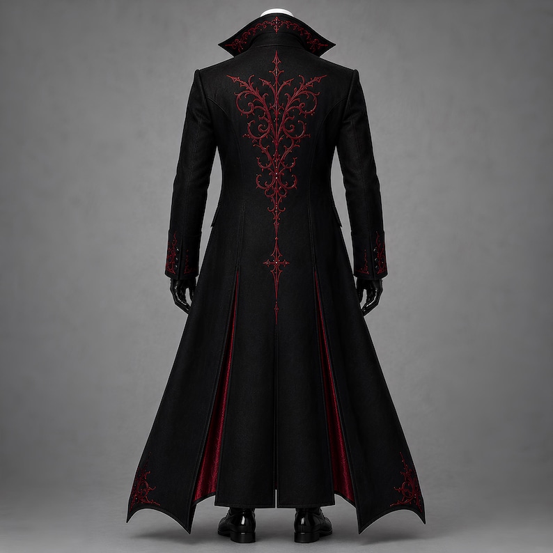 Back view of an elaborate Gothic vampire coat with ornate red embroidery extending across the shoulders and down the long black tailcoat. Contrasting crimson inner panels, sculpted tailoring and decorative hem details complete this Victorian steampunk design for cosplay, masquerade balls, gothic weddings and theatrical costumes.