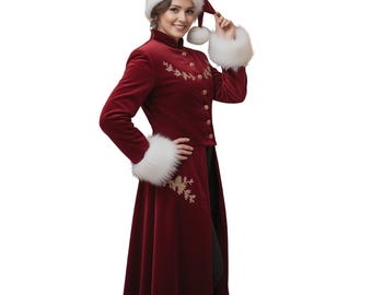 May include: A burgundy velvet coat with gold embroidery and matching Santa hat with white faux fur trim. The coat has a high collar and gold buttons. The Santa hat has a white faux fur trim and a red pom-pom.