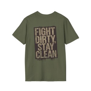 May include: Olive green t-shirt with the text "FIGHT DIRTY, STAY CLEAN" in a distressed, rectangular design. The text is in a bold, sans-serif font, with a grunge-style effect. The shirt is a classic crew neck style.