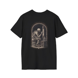 May include: Black t-shirt featuring a detailed illustration of a skeleton soldier seated next to a rocket. The artwork is framed within an arched design, with the rocket displaying text. The design is in shades of gray and tan.