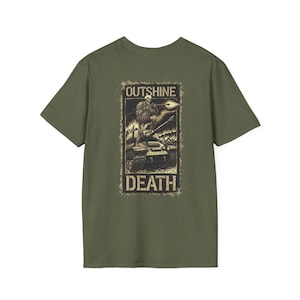 May include: Olive green t-shirt featuring a distressed graphic. The graphic depicts a skeleton figure on a tank with the words "OUTSHINE DEATH" in a rectangular frame. The design is in shades of black and tan.