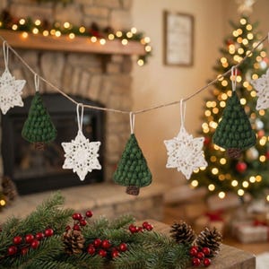 May include: A festive Christmas garland featuring crocheted ornaments. The garland includes green tree and white snowflake shapes, strung on twine. The background shows a fireplace, Christmas tree, and holiday decorations.