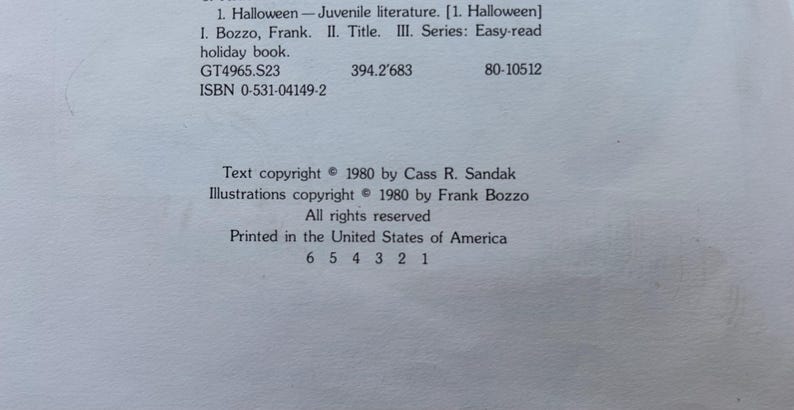 May include: A white book copyright page with black text. It lists 1. Halloween - Juvenile literature. I. Bozzo, Frank. II. Title. III. Series: Easy-read holiday book. GT4965.S23 394.2'683 80-10512 ISBN 0-531-04149-2. Text copyright 1980 by Cass R. Sandak.
