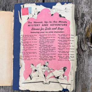 May include: A vintage book cover with a blue spine and a distressed, torn pink paper overlay featuring the text The Newest, Up-to-the-Minute MYSTERY AND ADVENTURE Stories for Girls and Boys, listing various character titles and illustrations.