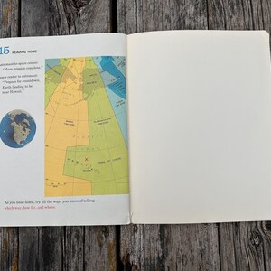 May include: An open book page titled 15 Heading Home, featuring a dialogue between an astronaut and space centre, a small circular image of Earth, and a colourful map showing time zones and the Pacific Ocean with a red X marking Hawaii.