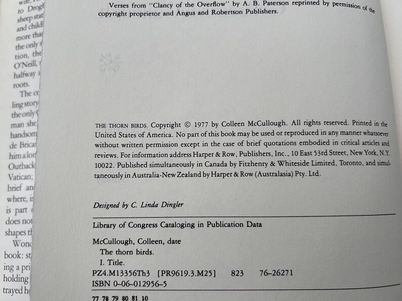 May include: A white book copyright page featuring black text. The text includes the title The Thorn Birds, copyright 1977 by Colleen McCullough, and Library of Congress Cataloging in Publication Data. The ISBN 0-06-012956-5 is printed at the bottom.
