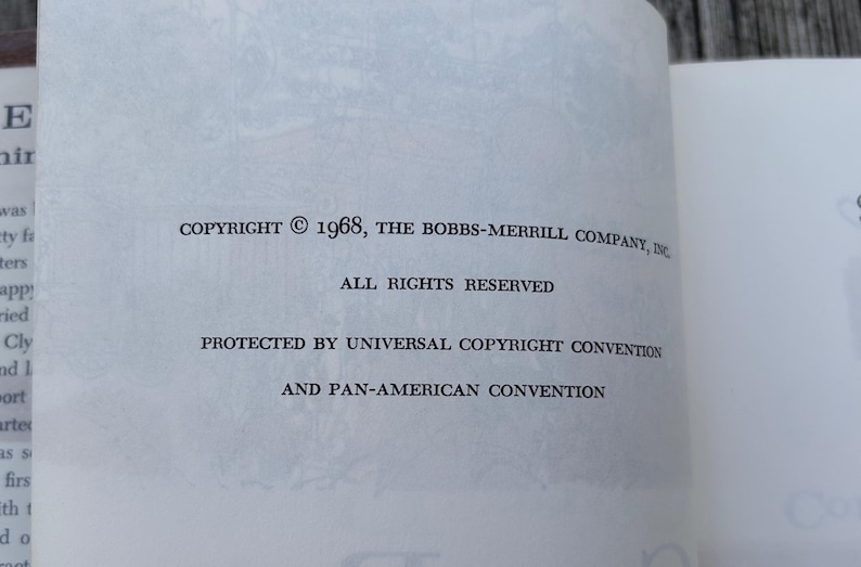 May include: A white book page with black printed text that reads: COPYRIGHT &copy; 1968, THE BOBBS-MERRILL COMPANY, INC. ALL RIGHTS RESERVED. PROTECTED BY UNIVERSAL COPYRIGHT CONVENTION AND PAN-AMERICAN CONVENTION. The paper has a faint, light grey illustration.