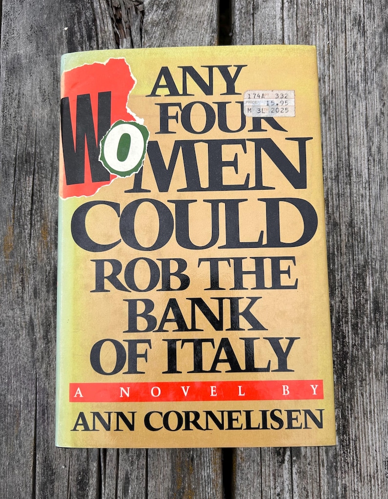 May include: A hardcover book with a yellow cover featuring the title Any Four Women Could Rob the Bank of Italy by Ann Cornelisen in bold black lettering. A red and green sticker partially covers the word Women on the front cover.