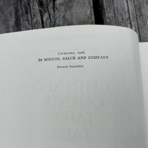 May include: The copyright page of a book featuring the text Copyright, 1926, By Minton, Balch and Company, followed by the line Eleventh Impression. The text is printed in black ink on a white paper page with a visible book binding crease.