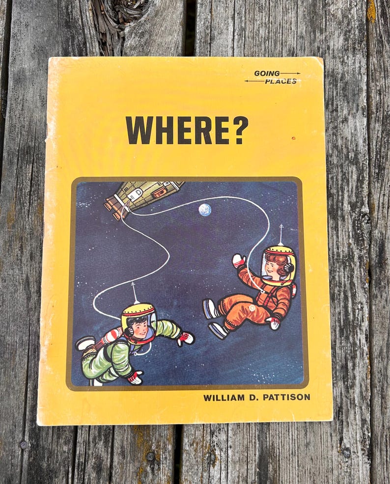 May include: A yellow softcover book titled WHERE? by William D. Pattison, featuring the text GOING PLACES. The cover illustration depicts two figures in space suits floating in a dark blue space scene with a spacecraft and a small planet.