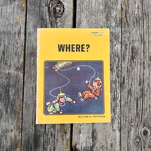 May include: A yellow softcover book titled WHERE? by William D. Pattison, featuring a Going Places logo and a central illustration of two astronauts in space suits floating in the dark cosmos near a spacecraft and a small white planet.
