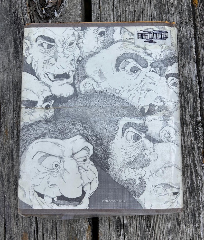 May include: A rectangular book cover featuring a black and white ink illustration of multiple grotesque, troll-like faces with exaggerated features, sharp teeth, and textured skin. The ISBN 0-397-31621-6 is printed in small text at the bottom.