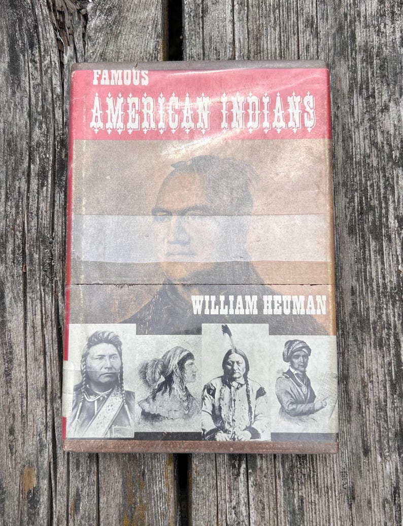 Puede incluir: Un libro de tapa dura titulado Famous American Indians de William Heuman. La portada presenta un gran retrato de un hombre sobre un fondo rojo y bronceado, y cuatro retratos hist&oacute;ricos m&aacute;s peque&ntilde;os en blanco y negro abajo.