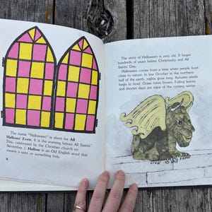 May include: An open book with two pages. The left page features a black-outlined illustration of two arched windows with a yellow and pink grid pattern and text about Halloween. The right page shows a green gargoyle illustration and text.