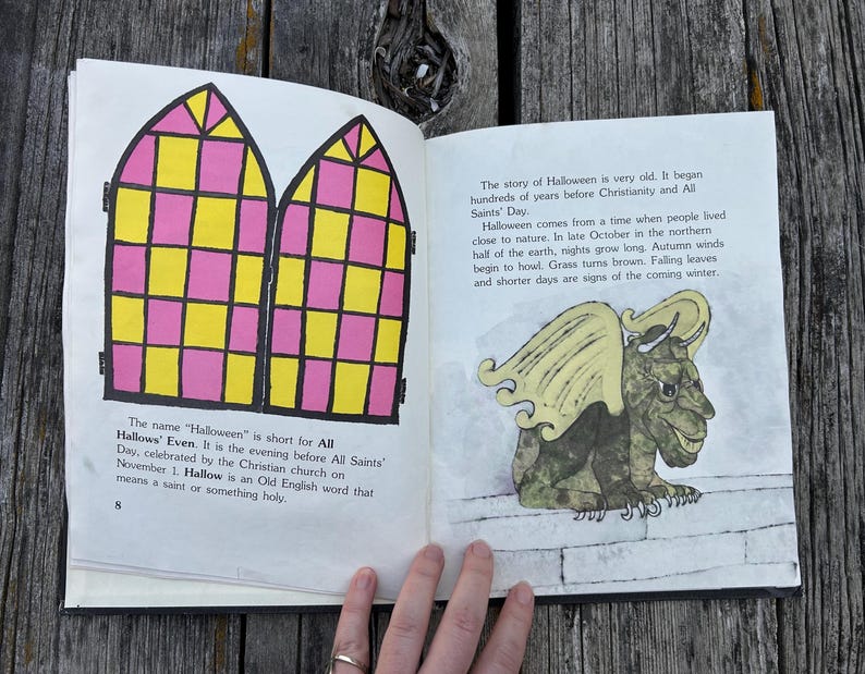 May include: An open book with two pages. The left page features a black-outlined illustration of two arched windows with a yellow and pink grid pattern and text about Halloween. The right page shows a green gargoyle illustration and text.