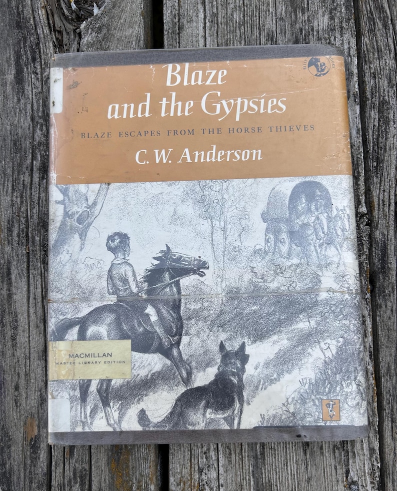 May include: A hardcover book titled Blaze and the Gypsies by C. W. Anderson, featuring the subtitle Blaze Escapes from the Horse Thieves. The cover displays a black and white illustration of a person riding a horse with a dog nearby and a wagon.
