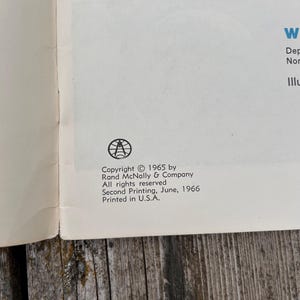 May include: A page from a book featuring a black circular logo with a globe and compass design. The text reads: Copyright 1965 by Rand McNally & Company. All rights reserved. Second Printing, June, 1966. Printed in U.S.A. The paper is off-white.