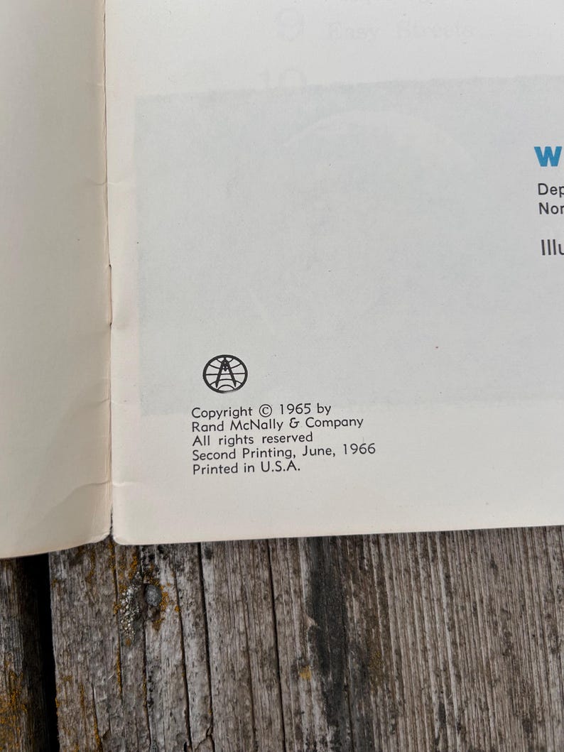 May include: A page from a book featuring a black circular logo with a globe and compass design. The text reads: Copyright 1965 by Rand McNally & Company. All rights reserved. Second Printing, June, 1966. Printed in U.S.A. The paper is off-white.