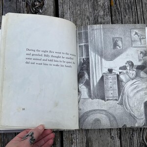 May include: An open book with black and white illustrations and text on page 10. The text reads: During the night Rex went to the window and growled. Billy thought he smelled some animal and told him to be quiet. He did not want him to wake his family.
