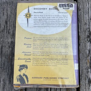 May include: The back cover of a Discovery Books volume by Garrard Publishing Company. It features a yellow and purple background with a white oval containing text about the series, including the headings Purpose, Reading Level, and Format.
