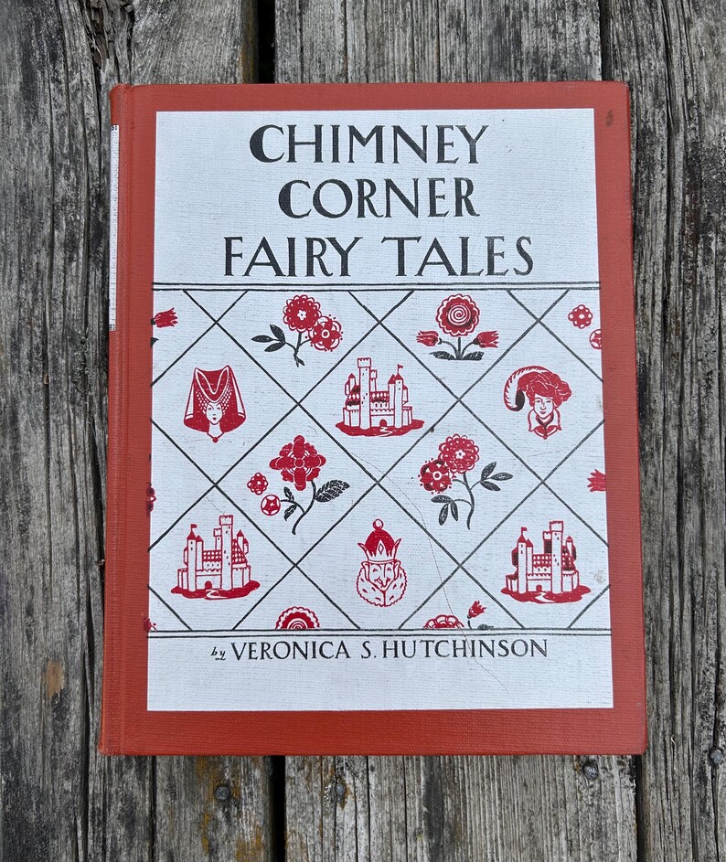 May include: A hardcover book titled Chimney Corner Fairy Tales by Veronica S. Hutchinson. The cover features a white background with a red diamond grid pattern containing illustrations of castles, flowers, and figures, framed by a red border.
