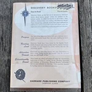 Puede incluir: La contraportada de un volumen de Discovery Books de Garrard Publishing Company. Presenta un fondo beige claro con un logotipo de estrella azul, texto que describe la serie y una ilustraci&oacute;n circular de una persona usando un telescopio.