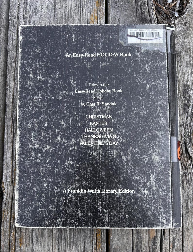 May include: A black, rectangular book cover with white text reading An Easy-Read HOLIDAY Book, Titles in the Easy-Read Holiday Book Series by Cass R. Sandak, CHRISTMAS, EASTER, HALLOWEEN, THANKSGIVING, VALENTINE'S DAY, and A Franklin Watts Library Edition.