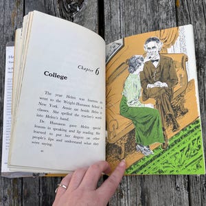May include: An open book showing Chapter 6 titled College. The left page contains text about Helen at the Wright-Humason School. The right page features a colour illustration of a person in a green skirt and striped top sitting on a couch with a man.