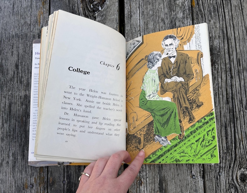 May include: An open book showing Chapter 6 titled College. The left page contains text about Helen at the Wright-Humason School. The right page features a colour illustration of a person in a green skirt and striped top sitting on a couch with a man.