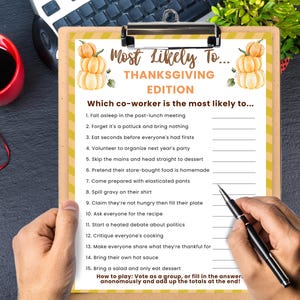 May include: A clipboard featuring a Thanksgiving-themed game titled "Most Likely To... THANKSGIVING EDITION". The game lists humorous scenarios for coworkers. A pen is held over the list, ready to be marked.