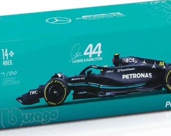 May include: A black and teal model race car in a teal box. The box features the number 44, the name Lewis Hamilton, and the text "F1 W14 E Performance." The model car is 1/24 scale.