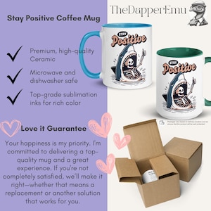 May include: White ceramic coffee mug with a blue handle and rim, featuring a shark design with a skeleton inside and the words "Stay Positive." The mug is shown in a box, ready for shipping.