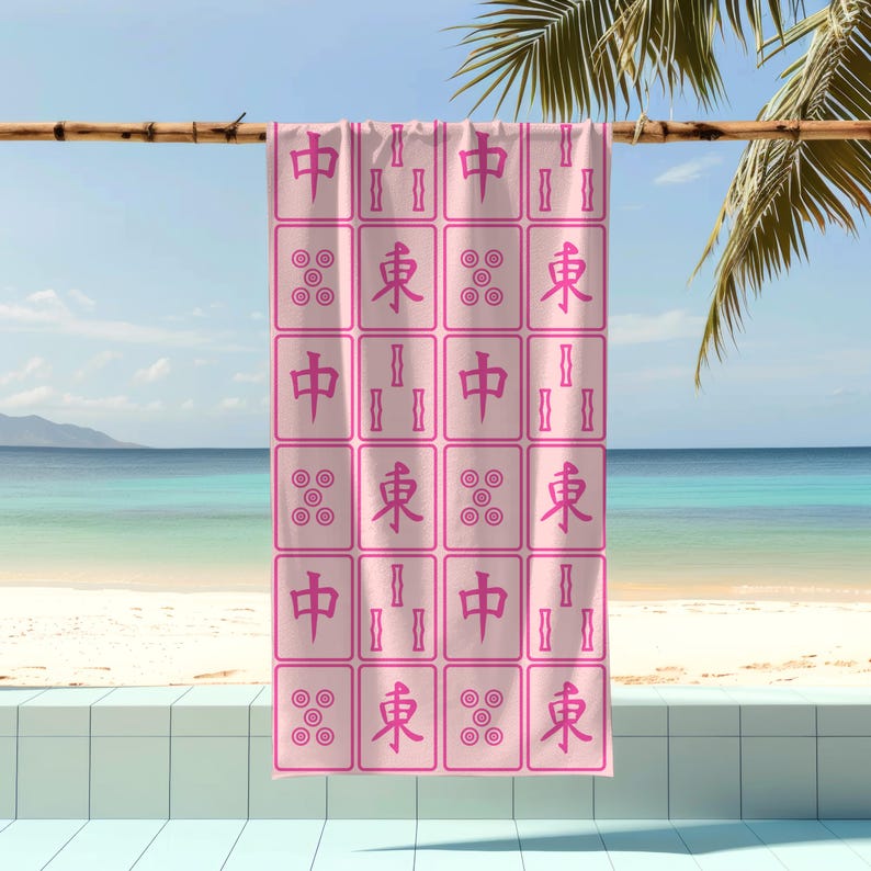 K&ouml;nnte beinhalten: Rosafarbenes Strandtuch mit einem sich wiederholenden Muster aus chinesischen Mahjong-Steinen. Die Steine ​​tragen die Zeichen "中", "東" und "發".